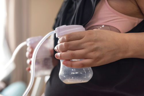 Expressing breast milk using an electric double breast pump.